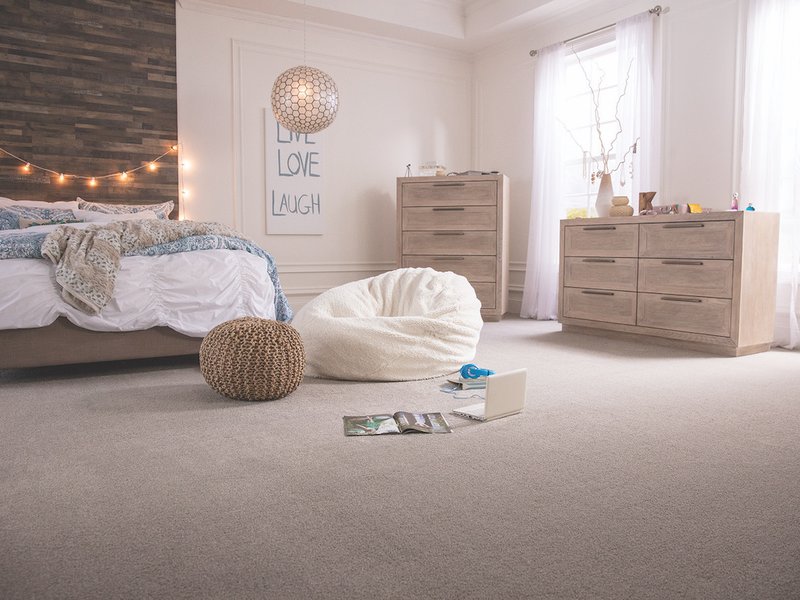 Suburban bedroom with beige carpet